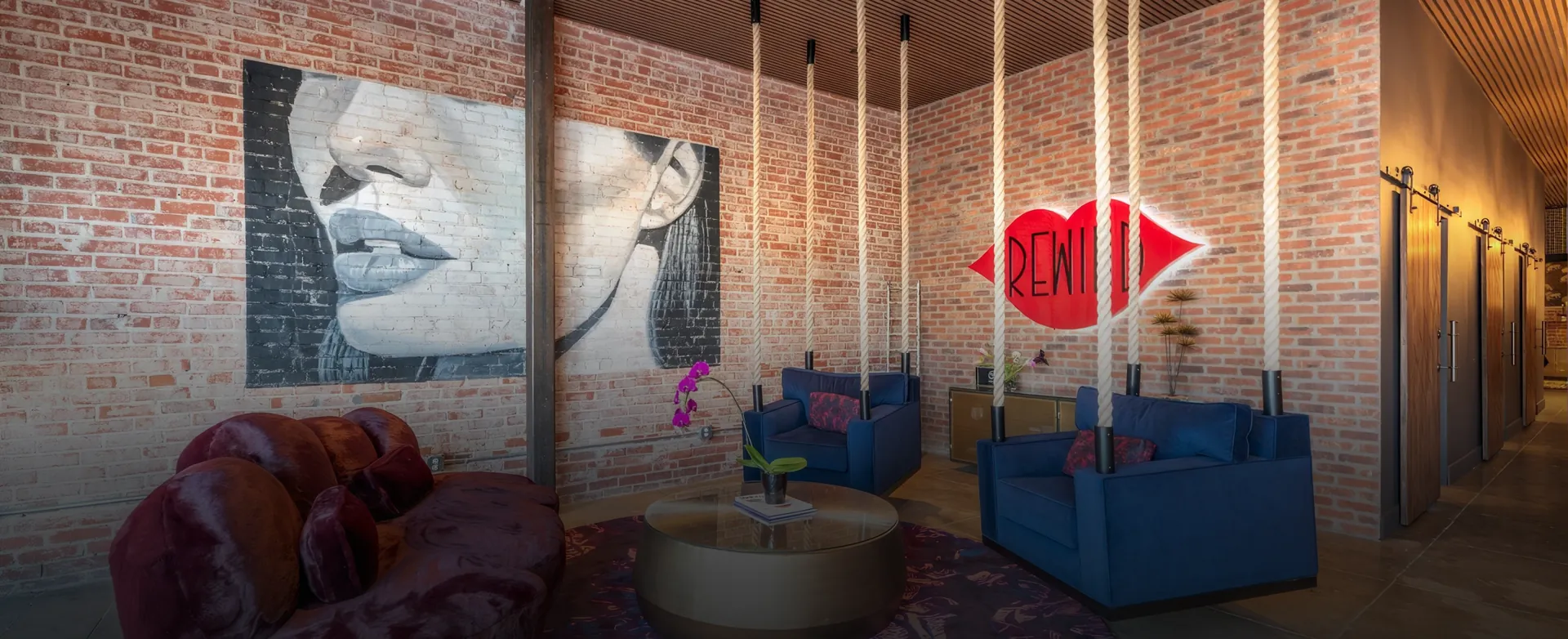 Rewind Aesthetics lounge in Culver City with brick walls, rope columns and the red Rewind lips sign