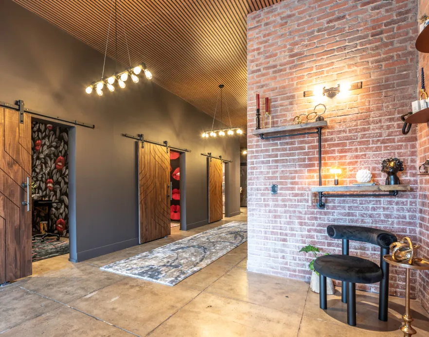 Hallway with sliding barn doors and pendant lights