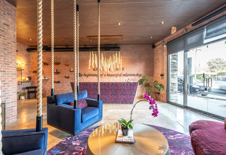 Lobby lounge with rope columns, blue velvet chairs and the Rewind sign